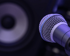 Microphone with speaker in background