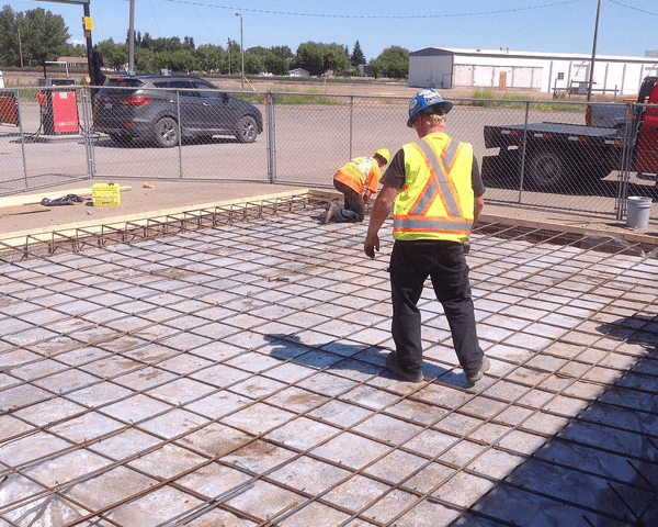 Workers preparing to pour a concrete slab