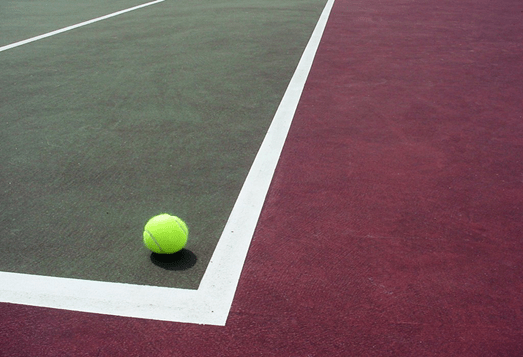 tennis ball landing in corner of court