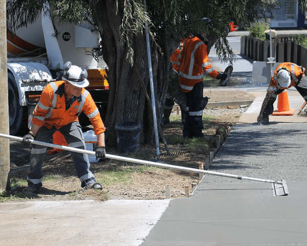 Workers finishing a concrete surface